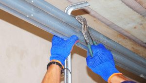 Homeowner Working On Garage Door